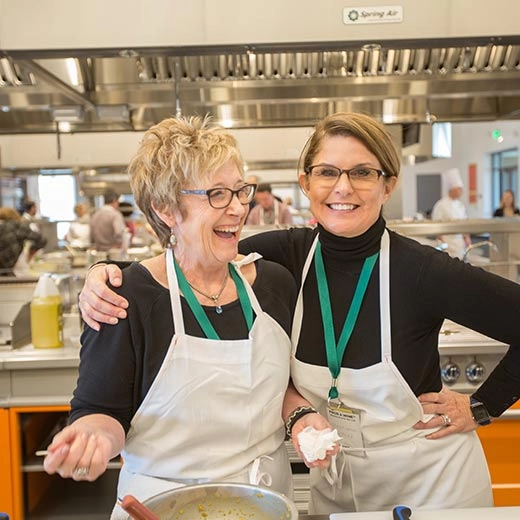 two women enjoying a cooking class at the CIA at Copia
