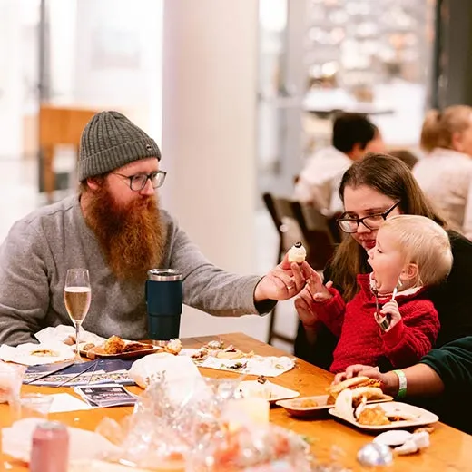 Man, woman, and boy enjoying dinner at Fantastic Mr. Fox Flavors of Film event at CIA at Copia in Napa, CA.